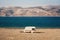 Caravan on shore of lake among desert and mountains, Uzbekistan