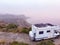 Caravan with solar panels on roof on coast, Spain. Aerial view