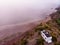 Caravan with solar panels on roof on coast, Spain. Aerial view