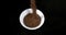 Caraway or Cumin Seeds, carum carvi, Seeds falling into a Bowl against Black Background, Slow motion