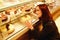 Carb addiction. Dieting girl with expressions looks at tempting sweets in shop window