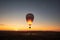 carbon dioxide balloon rising into the air, with sunset in the background