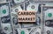 Carbon market symbol. Concept words `carbon market` on wooden blocks on a beautiful background from dollar bills. Business and