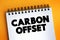 Carbon Offset text on notepad, concept background