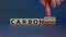 From carbon positive to neutral. Hand flips cubes and changes words `carbon positive` to `carbon neutral`. Beautiful white