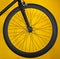 Carbon wheel for road bicycle on yellow background