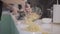 Carbonara pasta preparing on pan. Man hand close up puts on plates spaghetti with shrimps milk and cream
