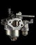 Carburetor, part of a gasoline internal combustion engine, spare part, isolated on a black background