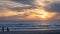 Carcavelos beach filled with many surfers at Sunset, Lisbon, Portugal