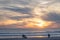 Carcavelos beach filled with many surfers at Sunset, Lisbon, Portugal