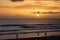 Carcavelos beach filled with many surfers at Sunset, Lisbon, Portugal