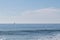 carcavelos beach with surfers and boat