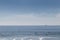 carcavelos beach with surfers and boat