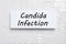 Card with phrase Candida Infection on white puzzle pieces, top view