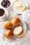 Cardamom Buns served with butter, jam and coffee closeup on the table. Vertical top view