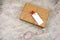 cardboard box with cloth pin with red heart and empty white label with place for text marble background