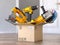 Cardboard box with elecric tools and construction equipment angle grinder, electric drill and jigsaw.  Buying online and fast