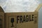 Cardboard box filled with bubble wrap and the sign fragile on it