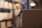 Cardboard box lying on logistics warehouse room shelf