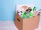 In a cardboard box plastic, glass bottles, cans, paper. The concept of separate sorting of garbage, environmental protection