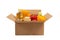 Cardboard box with a set of food on a white isolated background. Fruits, vegetables, canned food, vegetable oil, spaghetti. Food