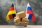 Cardboard boxes in a food basket and two flags on an abstract background, the concept of trade between Germany and Russia