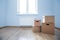 Cardboard boxes on laminate floor in empty room