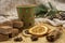 Cardboard disposable Christmas glass with a drink and various sweets and aromatic spices on a wooden tray