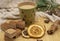 Cardboard disposable Christmas glass with a drink and various sweets and aromatic spices on a wooden tray