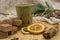 Cardboard disposable Christmas glass with a drink and various sweets and aromatic spices on a wooden tray