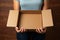 Cardboard embrace Female hands cradle an open empty brown box