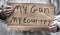 Cardboard handwritten sign, My Gun, My Country, gun laws, gun control