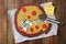 Cardboard pizza and Happy Fools` Day note on wooden table, flat lay