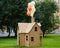 Cardboard playhouse in the backyard for kids. Eco concept