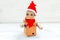 Cardboard robot with hands in santa hat on a white wooden background. Christmas composition