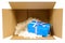 Cardboard shipping delivery box with blue gift inside and polyst