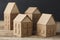 Cardboard toy houses on wooden background. Sale or rental of housing. Neighbors in house. Comfortable life in suburbs