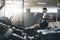 Cardio Training. Sports Man Exercising On Rowing Machine At Gym