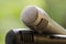 cardioid gray and black microphones on wooden railing with natural background