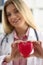 Cardiologist holds red heart in hands closeup
