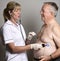 Cardiologist installs a ECG heart monitor onto a patient