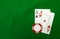 Cards showing pair of aces with chip on green