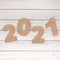 Cardstock Numbers 2021 Happy New Year Sign over table. 3d Rendering
