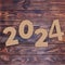 Cardstock Numbers 2024 Happy New Year Sign over table. 3d Rendering