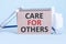 CARE FOR OTHERS text write on blackboard, medical concept