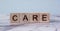 Care word written block. Care written on wood cube