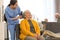 Care worker brushing elderly woman in hospice