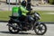 Careem eco-friendly green delivery motorcycle at the Dubai Marina Jumeriah area