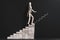 Career aspiration wooden man climbing stairs chalk