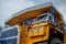 Career heavy dump truck Belaz. Yellow cab of a large car